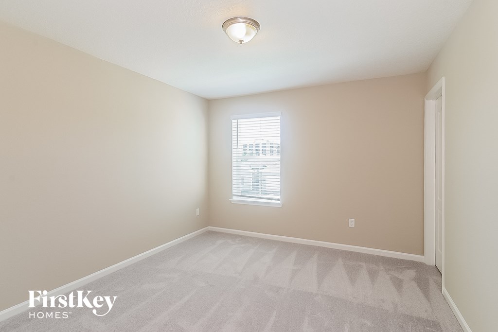 the living room of an empty house with a window