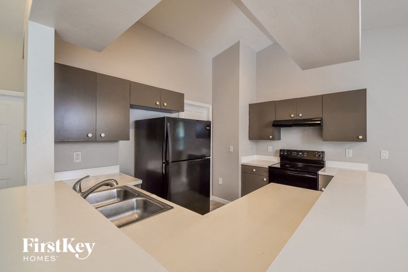 A kitchen with a stainless steel refrigerator and a stainless steel oven.
