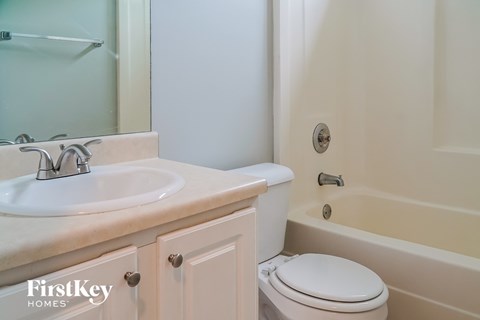 a bathroom with a sink and a toilet and a tub