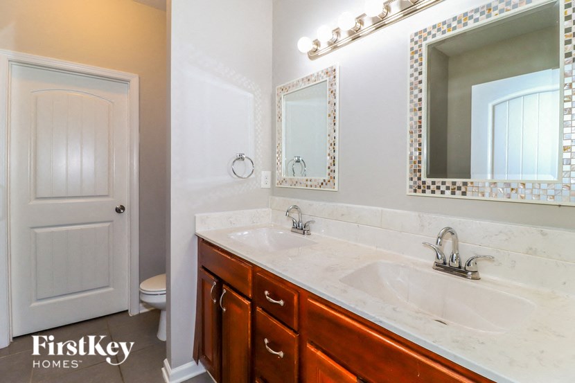 a bathroom with a sink and a mirror and a toilet