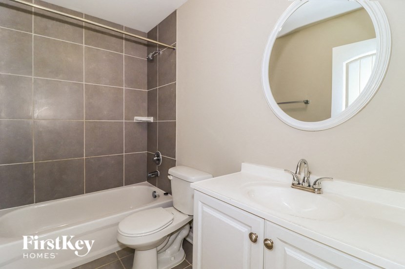 a bathroom with a sink toilet and a bath tub