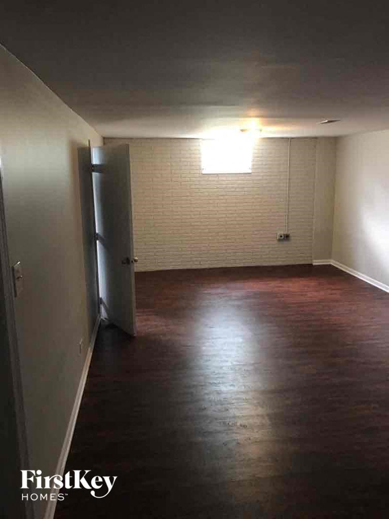 A room with wooden floors and a white door.