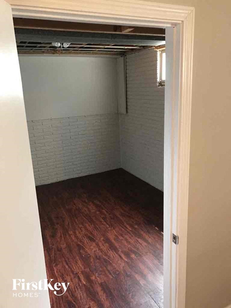 A room with a wooden floor and a white door.