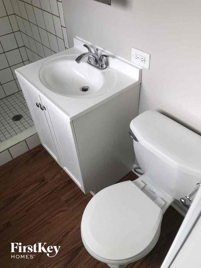 A white sink and toilet in a small bathroom.