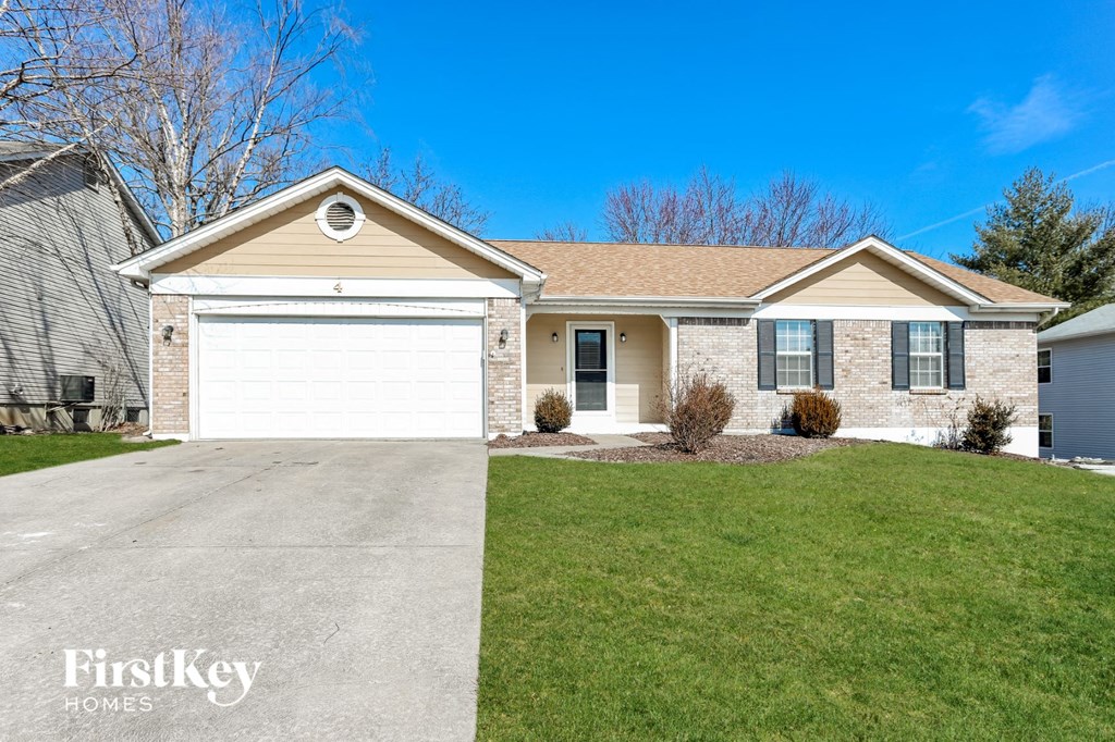 A house with a white garage door and a brown roof.