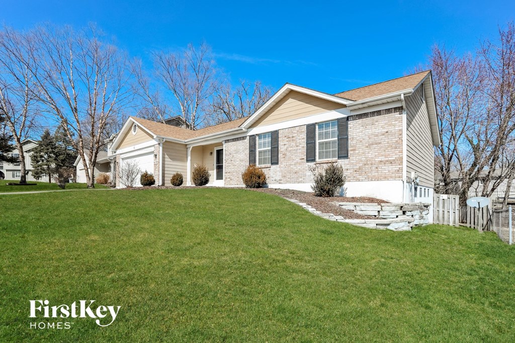 A house with a lawn in front of it.