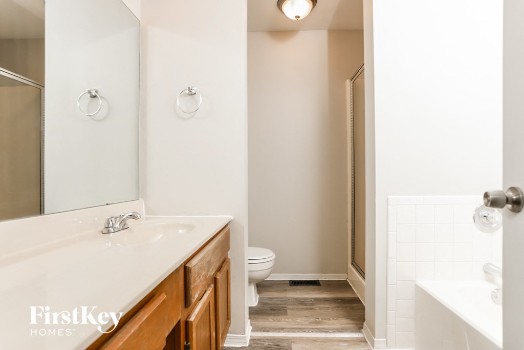 A bathroom with a white sink and toilet.