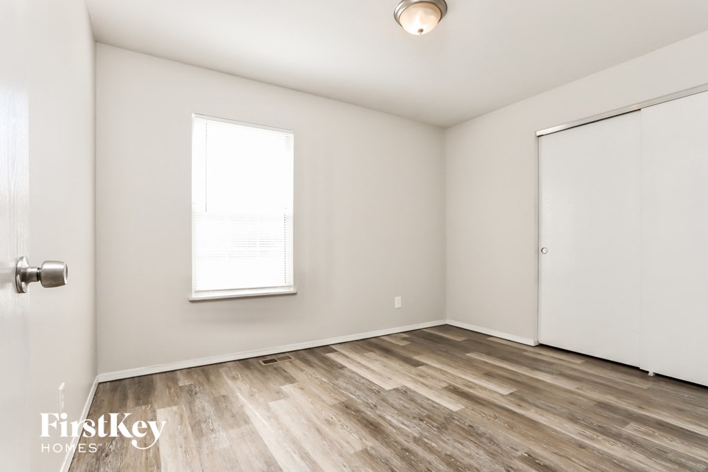 A room with a wooden floor and a sliding door.