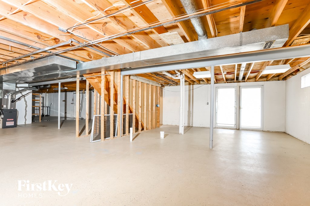 A room under construction with wooden beams and no walls.