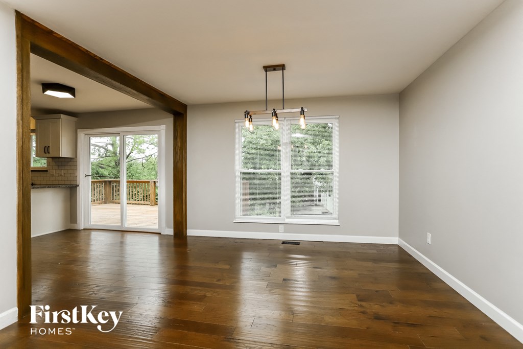 A room with wooden floors and a large window.