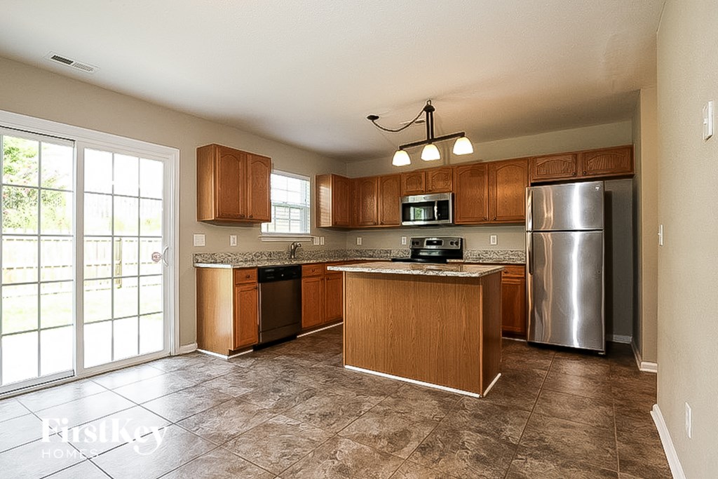 a kitchen with stainless steel appliances and wooden cabinets