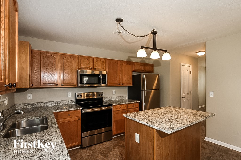 a kitchen with granite counter tops and stainless steel appliances