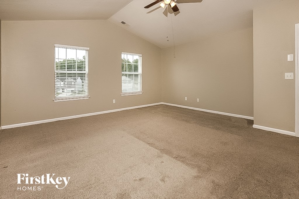 a bedroom with carpet and a ceiling fan