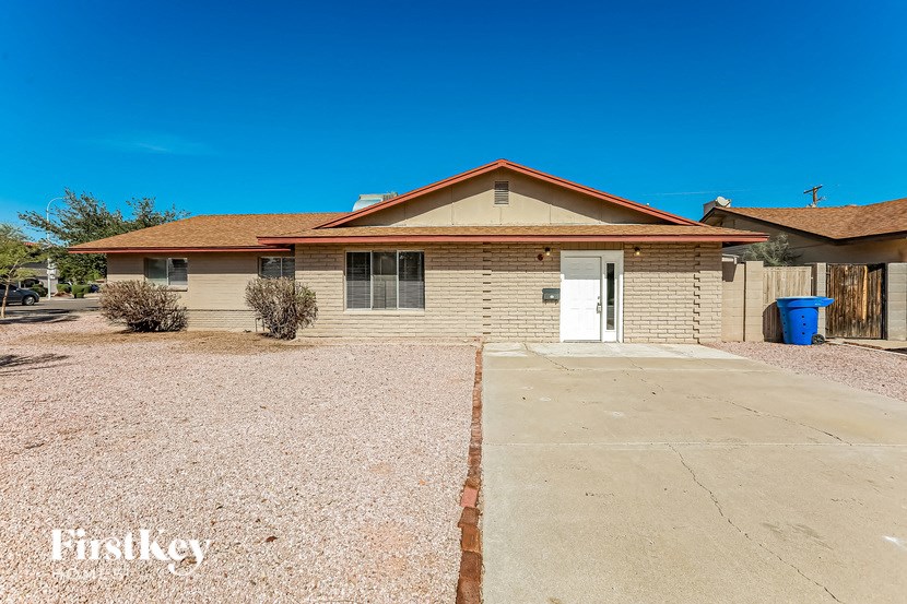 A house with a brown roof and a white door is shown.