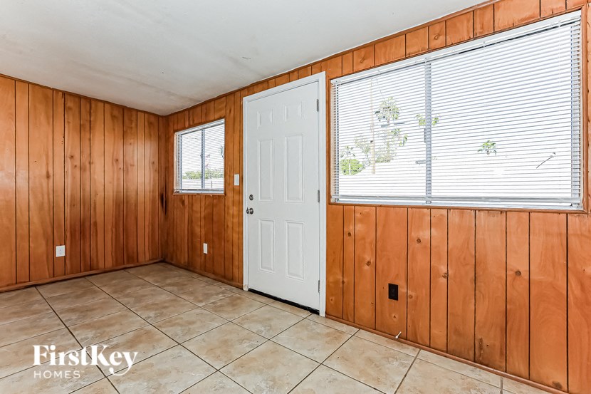 A room with wooden walls and a white door.