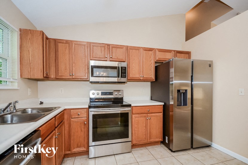 a kitchen with wooden cabinets and stainless steel appliances