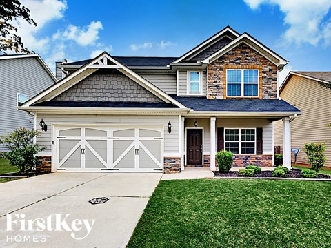 a renovated house with a white garage door and a lawn