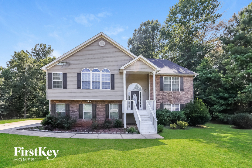 A house with a well-maintained lawn and a clear sky.