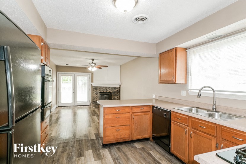 a kitchen with wooden cabinets and a stainless steel refrigerator