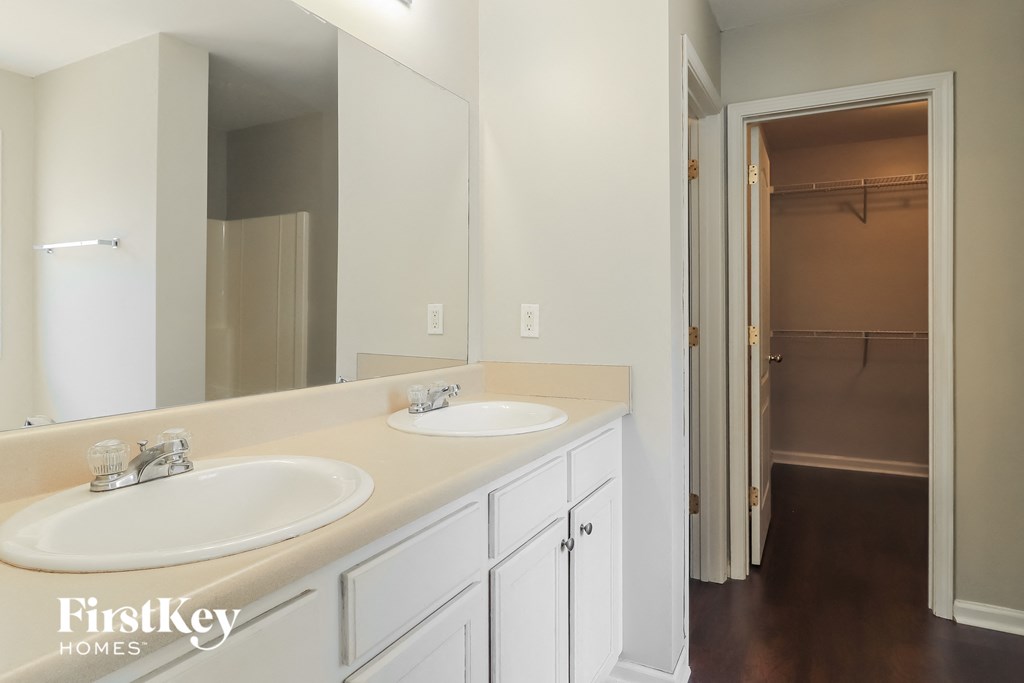 a bathroom with two sinks and a large mirror