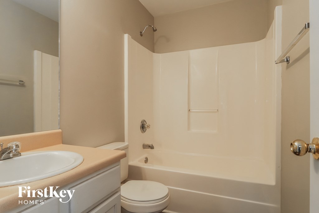 a bathroom with a sink and a toilet and a tub