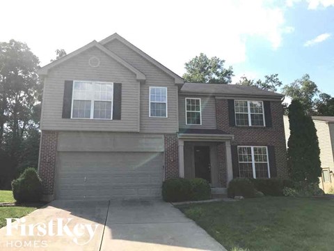 a house with a garage and a sidewalk in front of it
