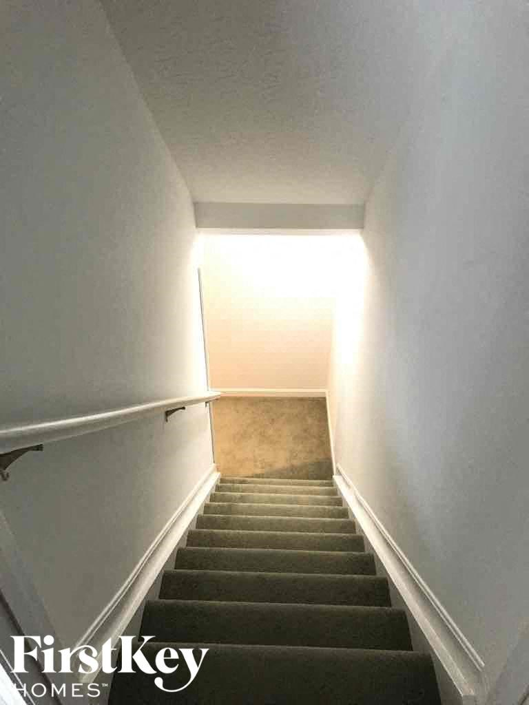 a stairwell with a light on the top of the stairs