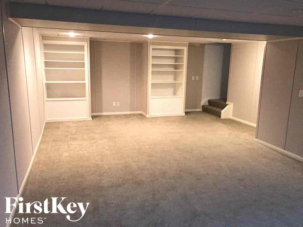 a walk in closet with shelves and a carpeted floor