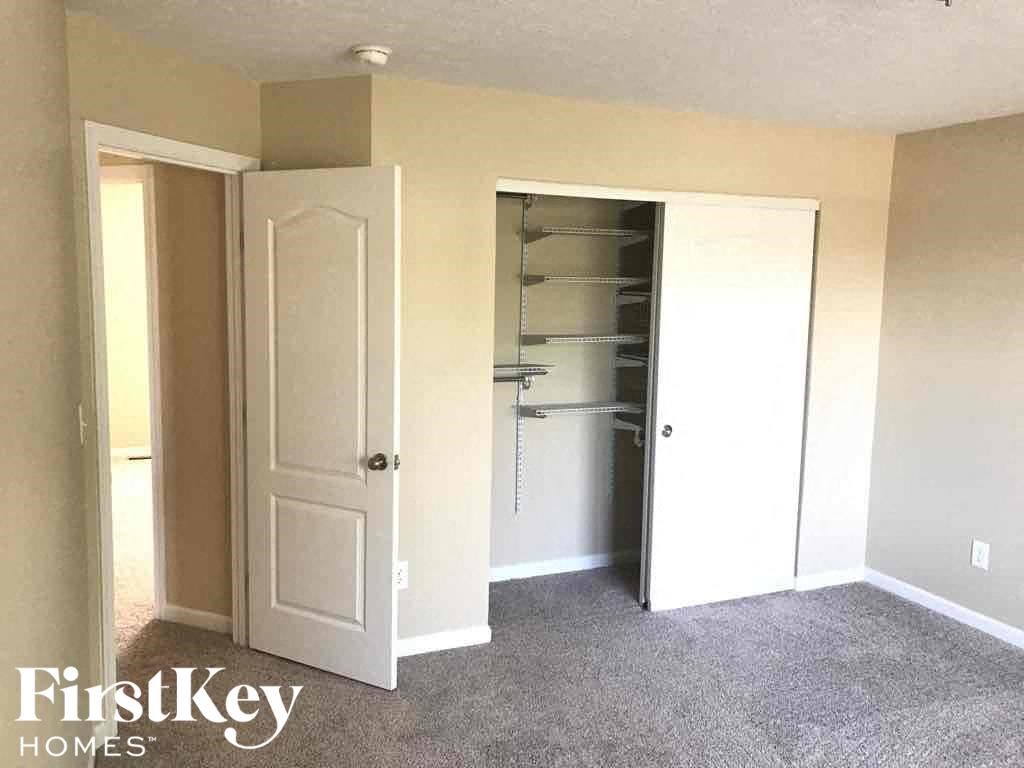 a closet in a room with a closet door and a closet