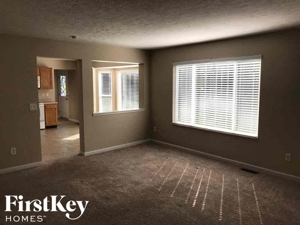 an empty living room with a large window