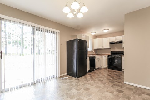 A kitchen with black appliances and a black refrigerator.