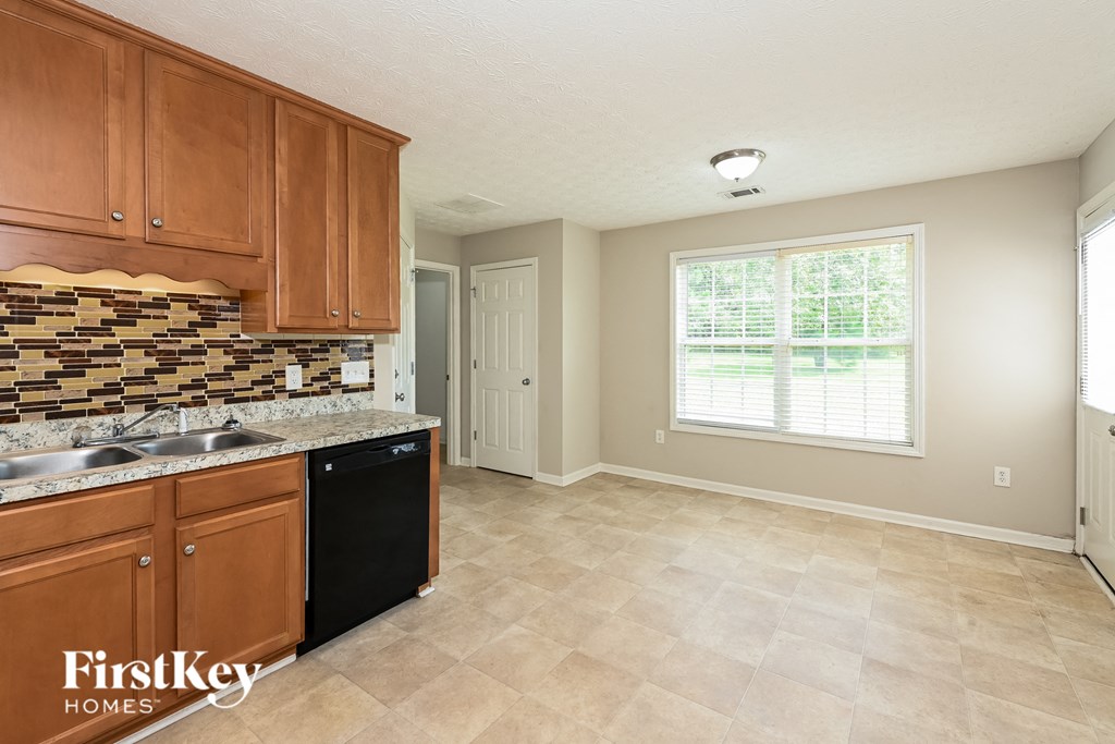 a kitchen with wooden cabinets and a sink and a window
