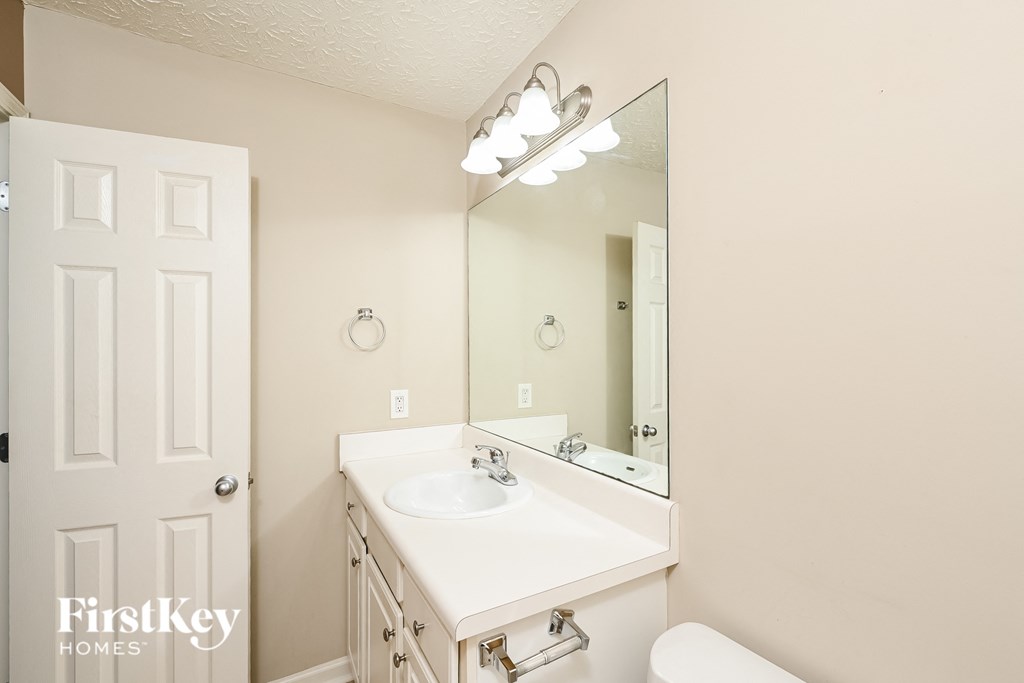 a bathroom with a white sink and a mirror