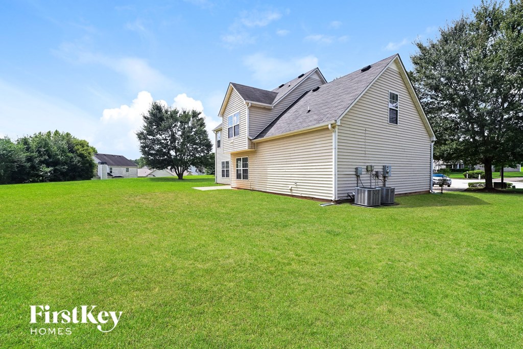 a home with a large yard in front of it
