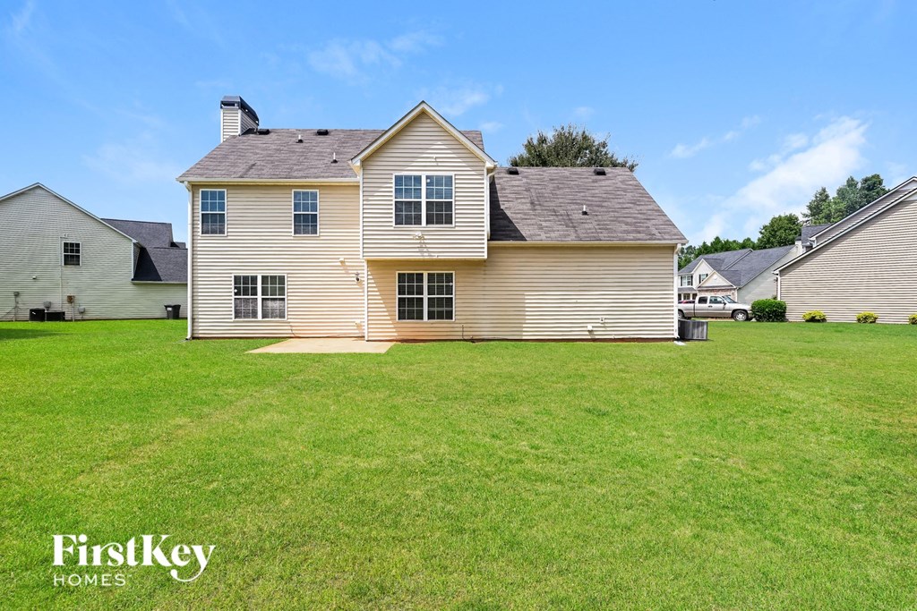 a home with a large lawn in front of it