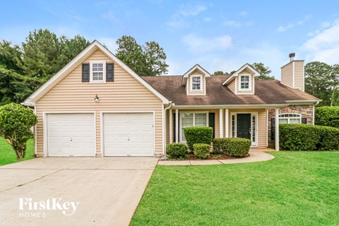 A house with a brown roof and a garage door.
