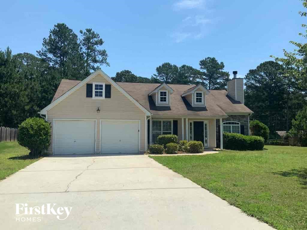a suburban house with a driveway and a lawn