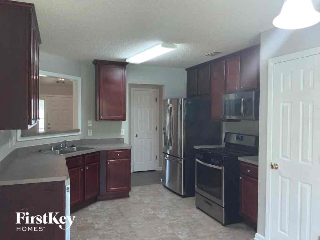 a kitchen with wooden cabinets and stainless steel appliances