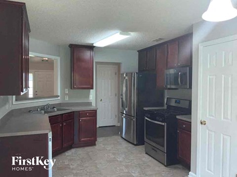 a kitchen with wooden cabinets and stainless steel appliances