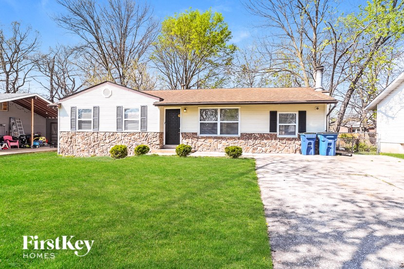 A house with a lawn in front of it.