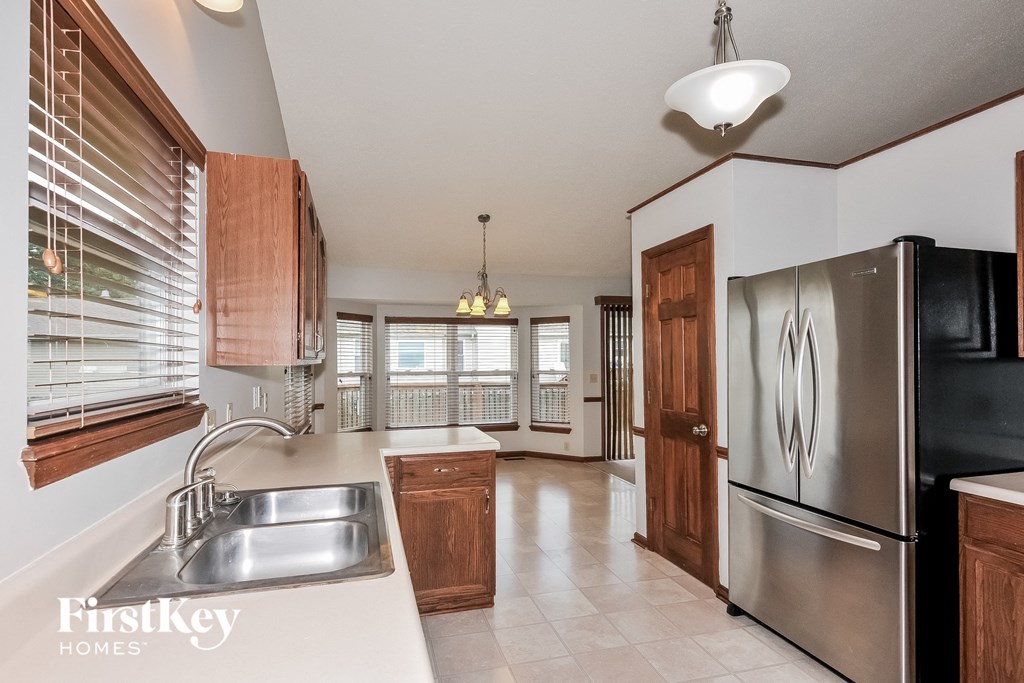 a kitchen with stainless steel appliances and a large window