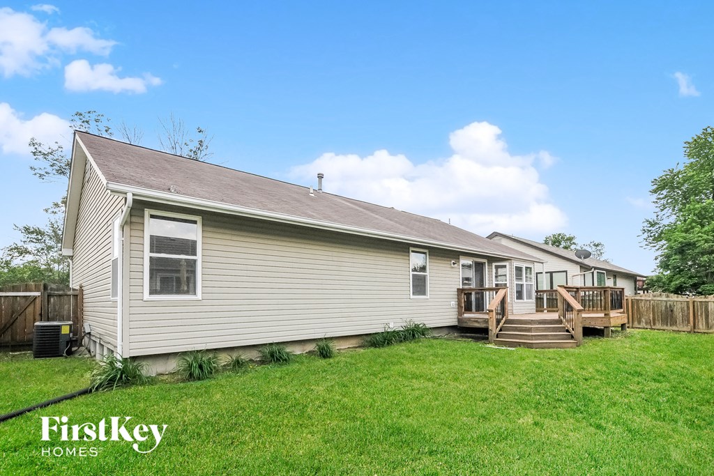 the exterior of a home with a backyard and a deck