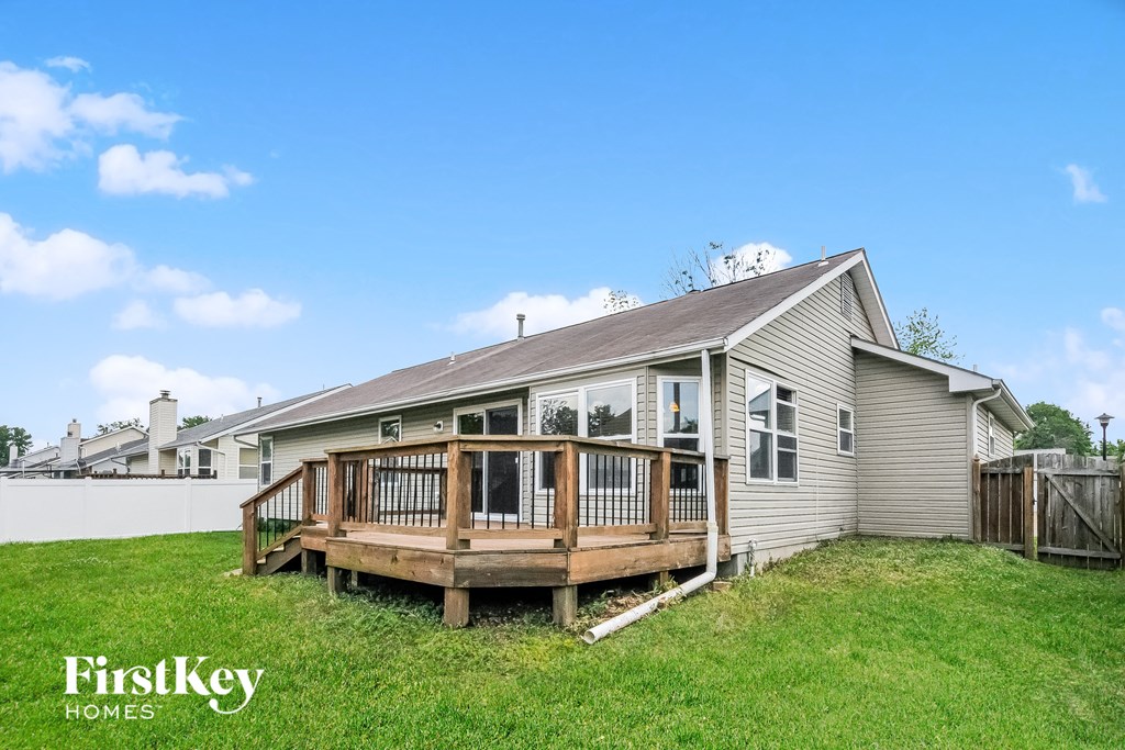 a backyard with a deck and a house