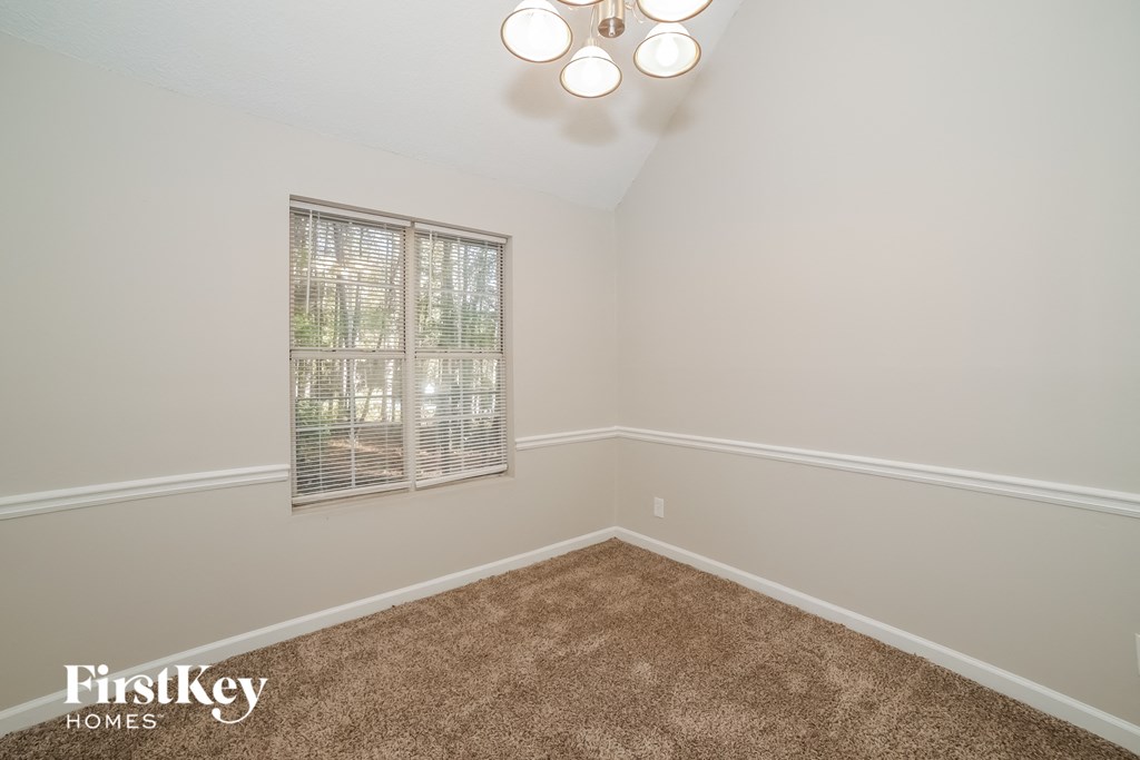 a bedroom with a carpeted floor and a window