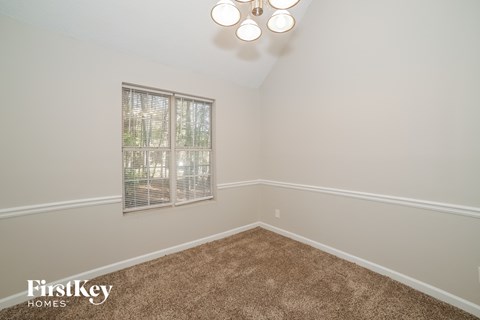 a bedroom with a carpeted floor and a window