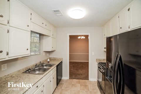 a kitchen with stainless steel appliances and white cabinets