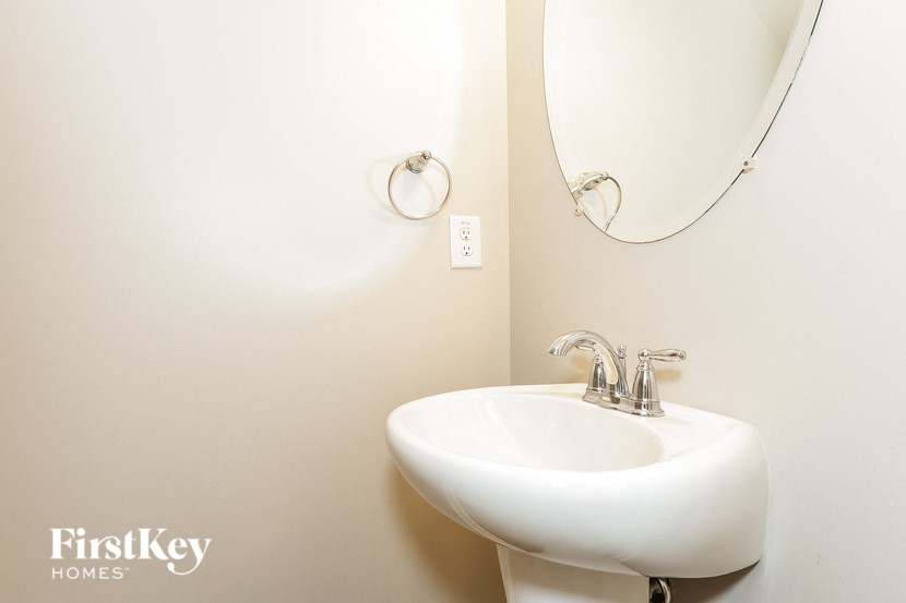 a small bathroom with a sink and a mirror