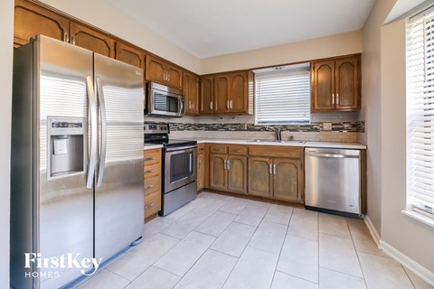 A kitchen with wooden cabinets and stainless steel appliances.