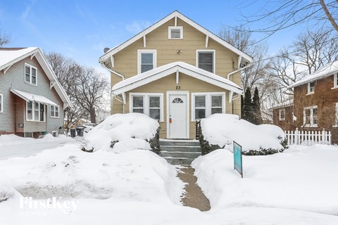 a house with snow on the ground and a white door