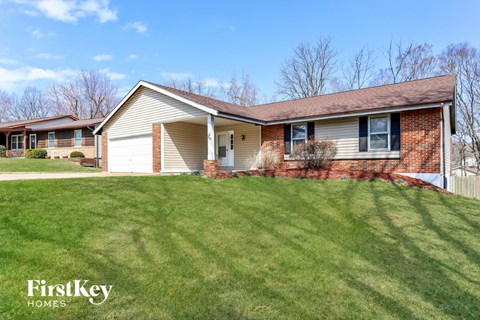 A house with a lawn in front of it.